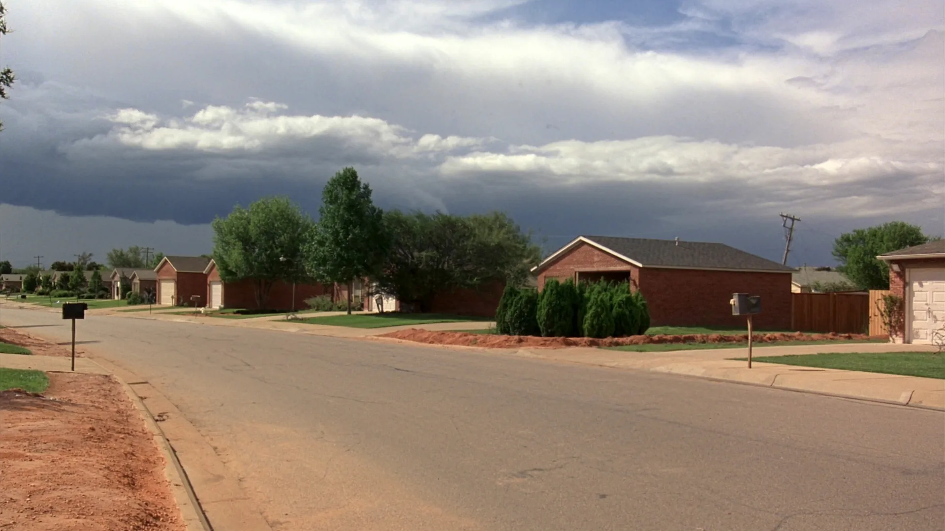 Storm clouds building over a residential street in the Oklahoma City metro